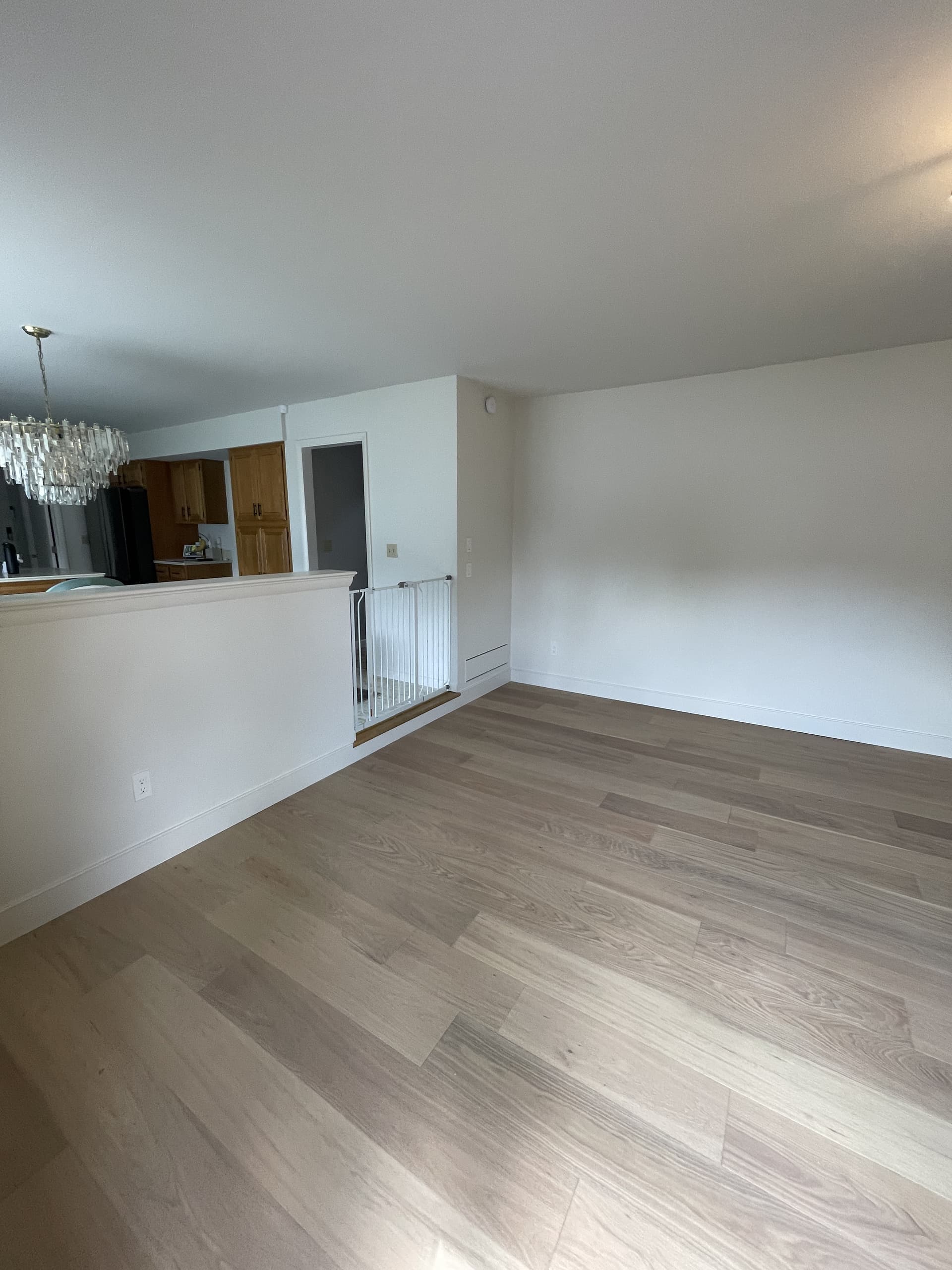 Light wood flooring installation in a finished living area.