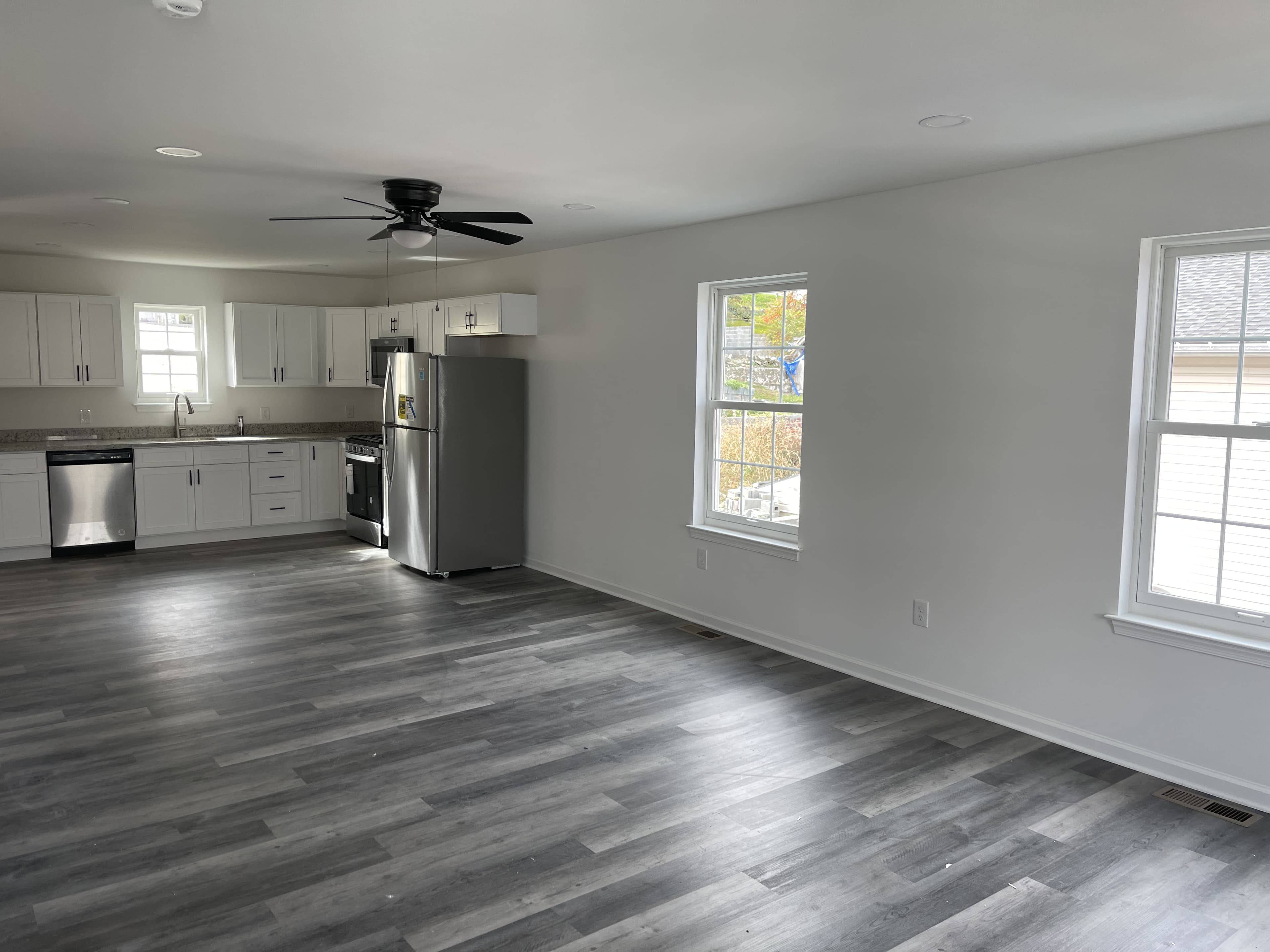 Kitchen remodel with updated finishes, flooring transition, and fixture detailing.