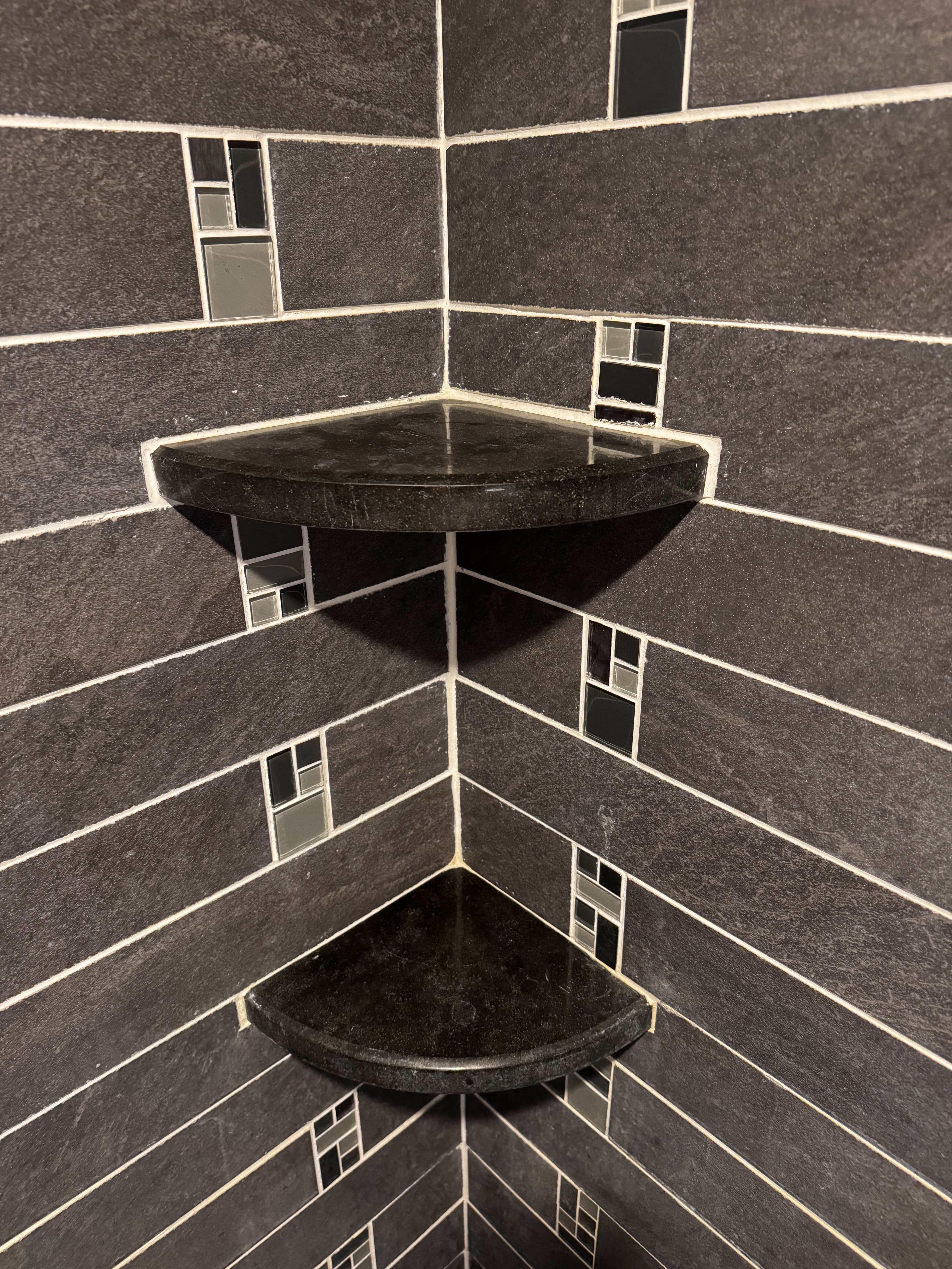 Bathroom shelving and storage detail after remodel.
