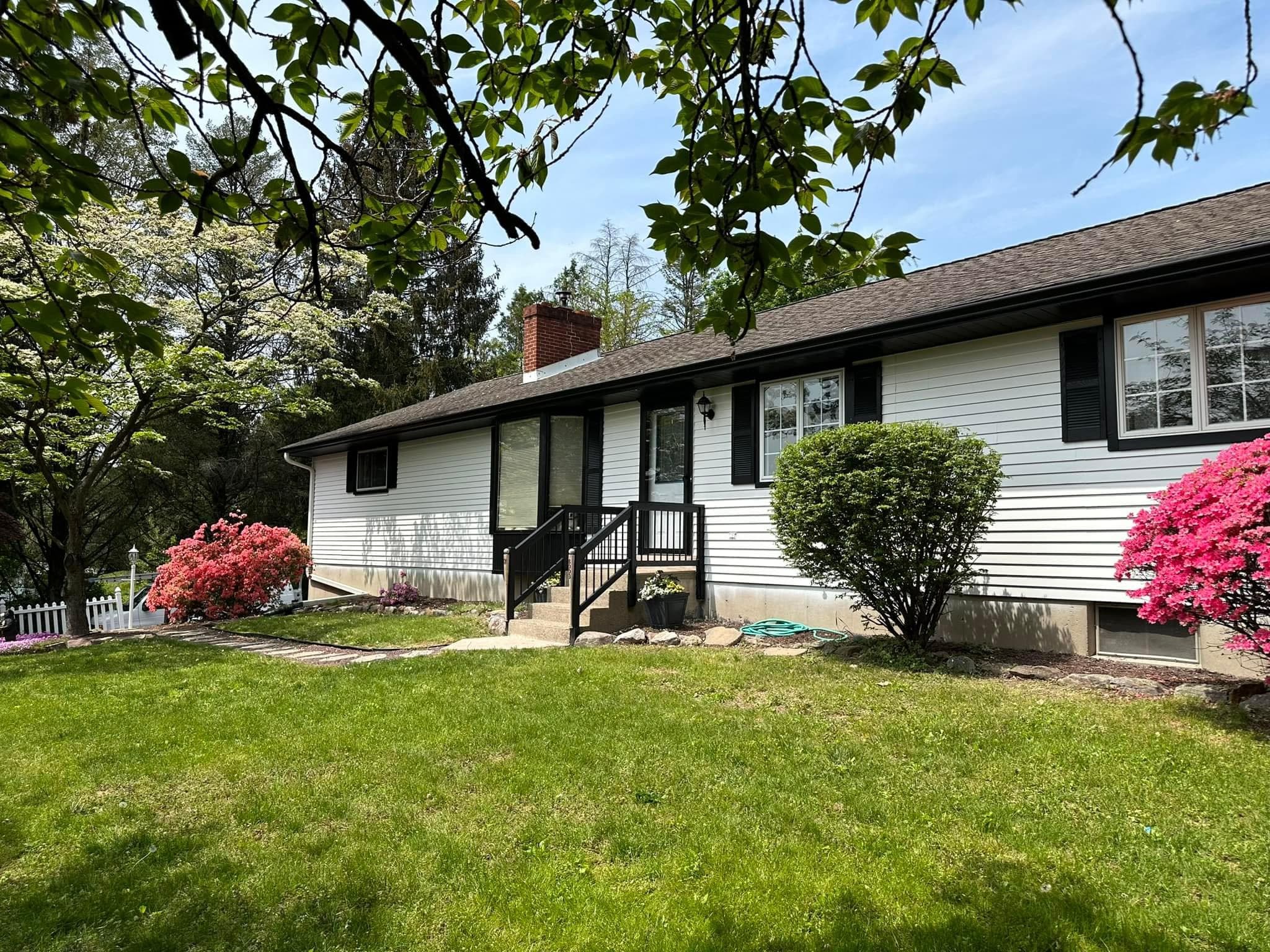 Ranch-style home exterior refresh in Berks County with updated black accents and clean siding lines.