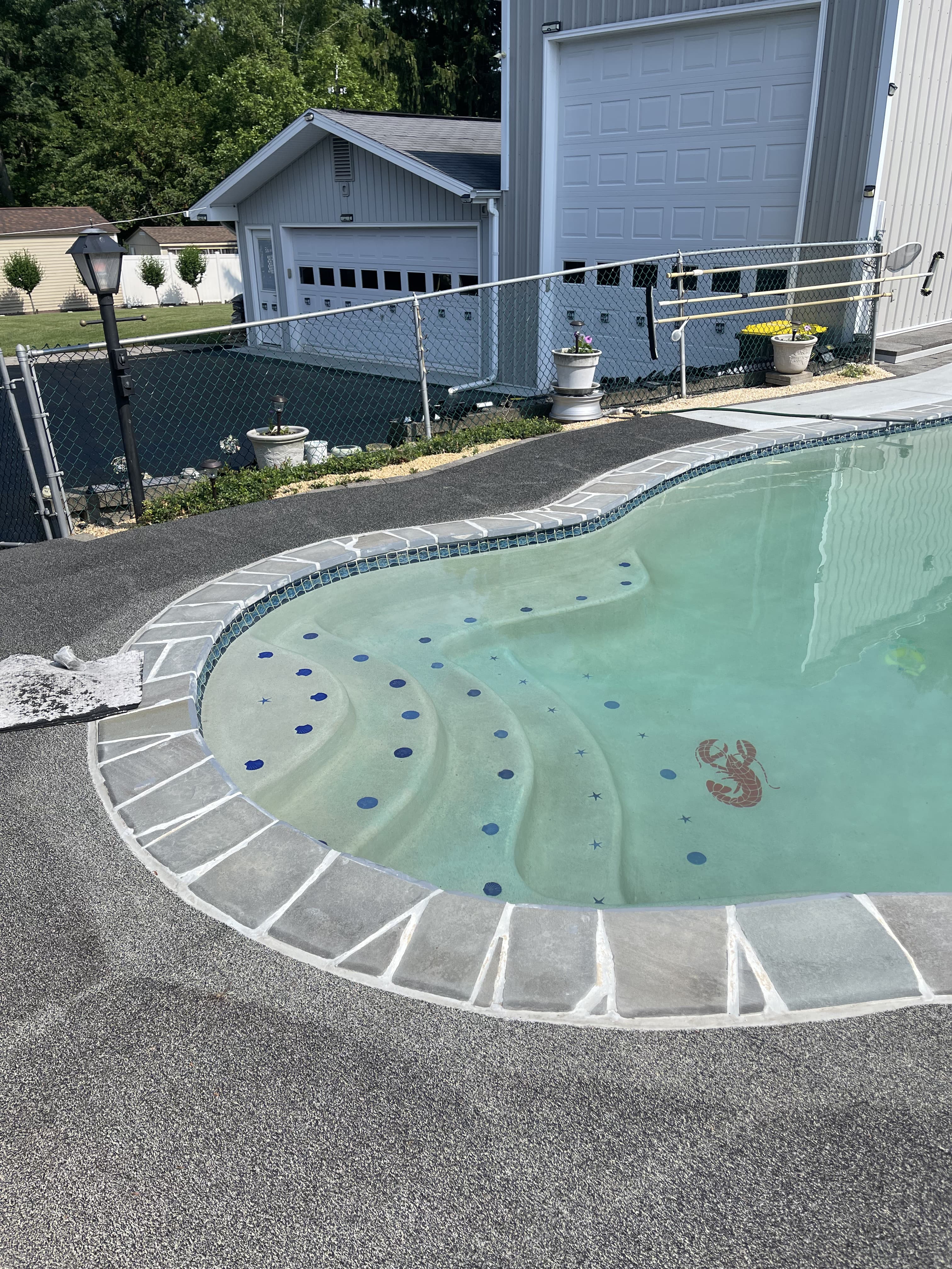 Pool patio step and curve detail after renovation in Bethlehem.