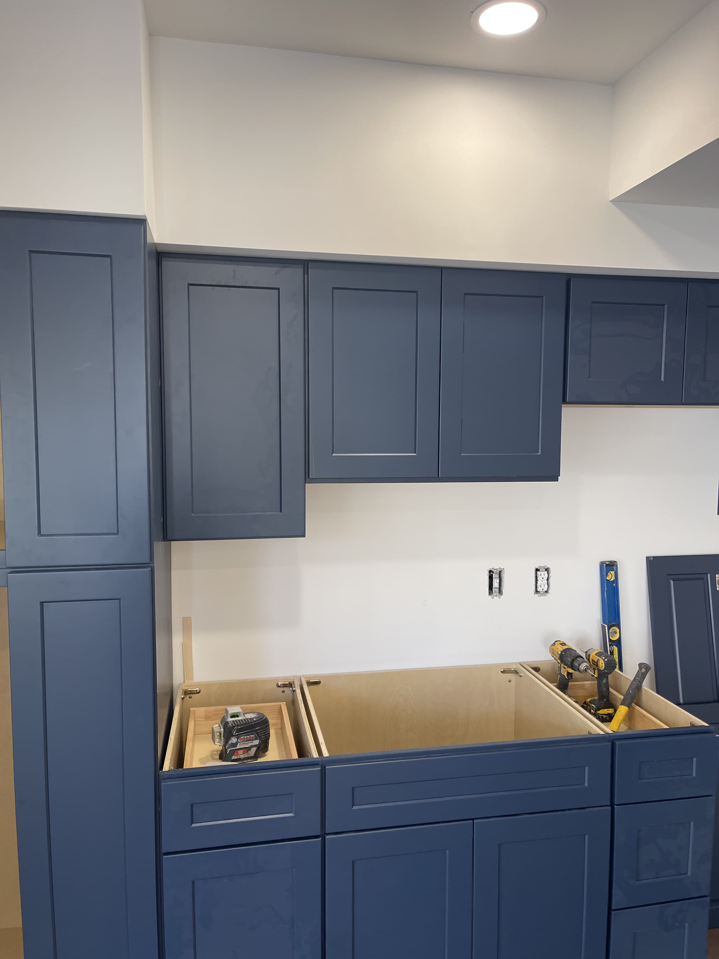 Updated kitchen overview with blue cabinet finish.