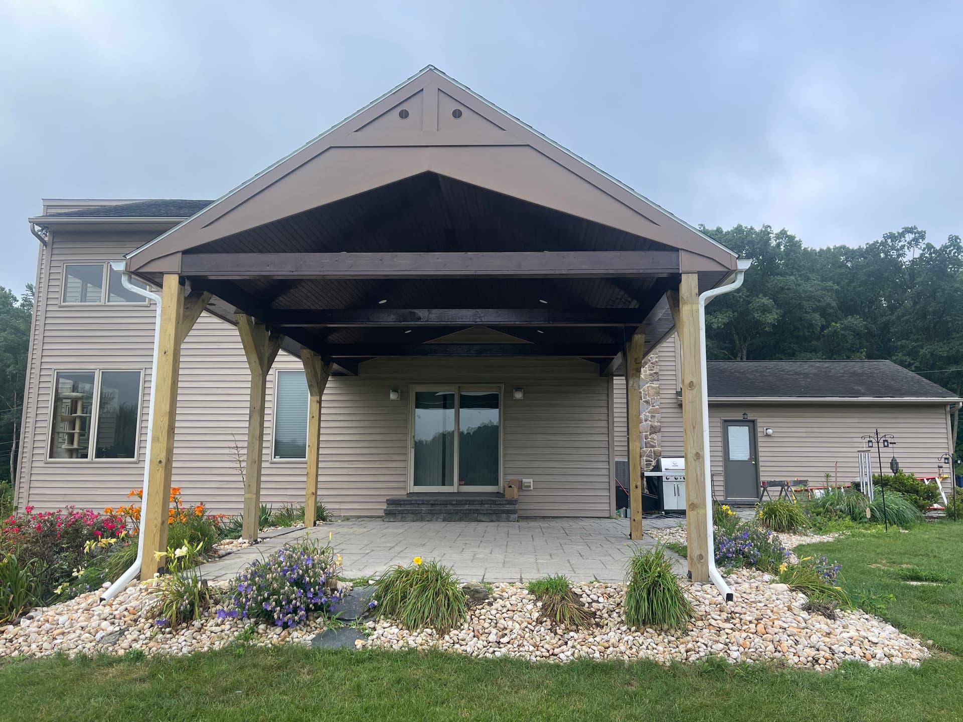 Outdoor living area showing paver field and pavilion roof structure.
