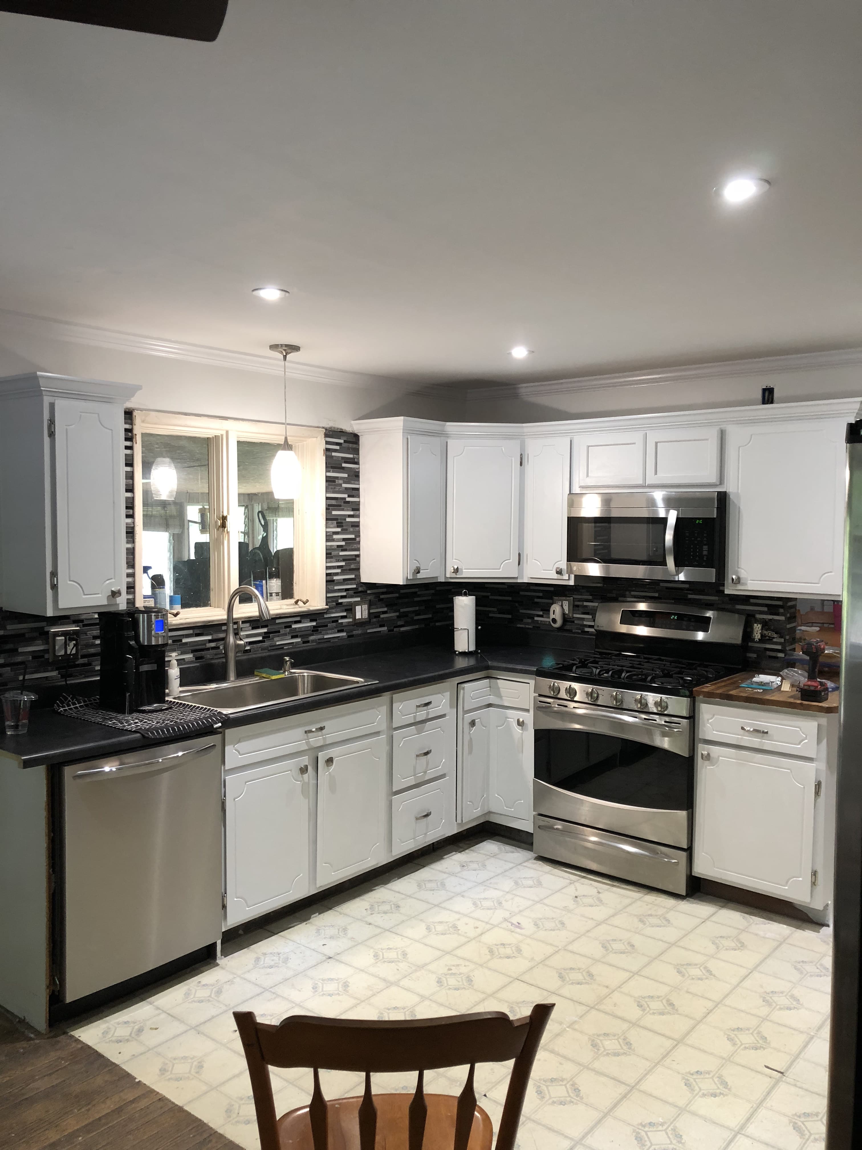 Kitchen after remodel — updated cabinets, counters, appliances, and lighting.